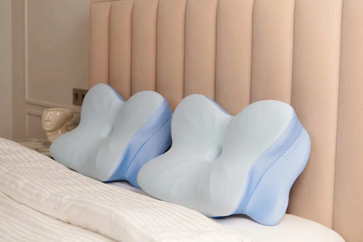 Two Derila Ergo ergonomic memory foam pillows on a made bed
